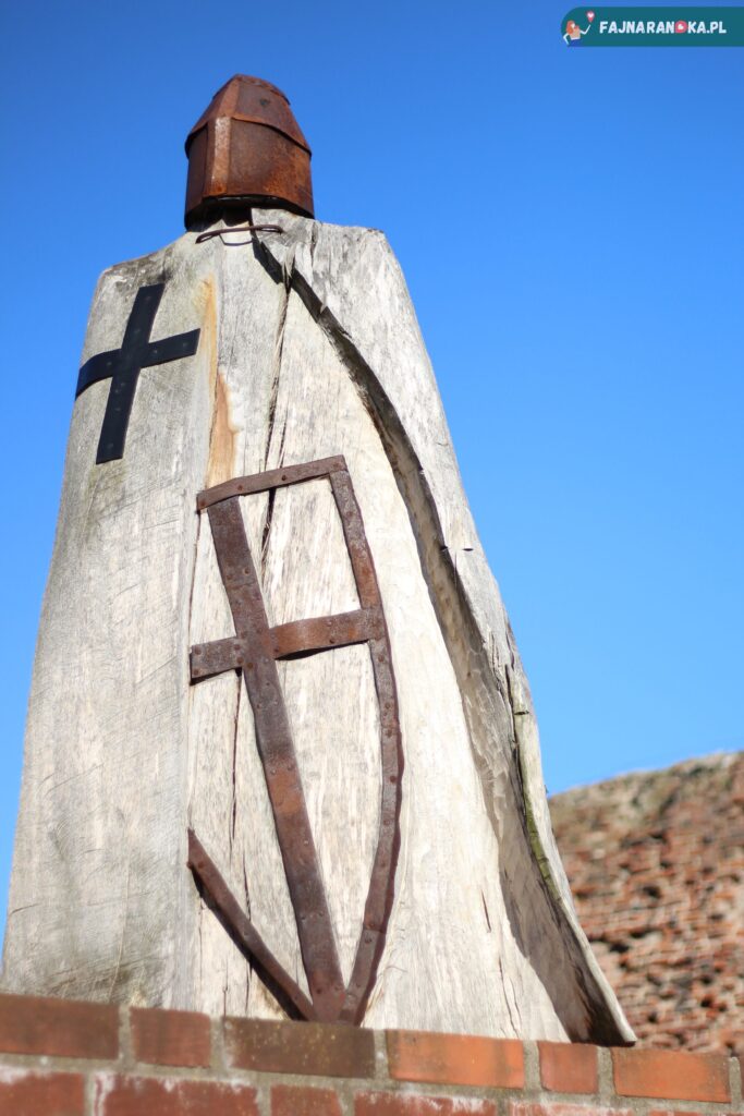 Drewniana rzeźba rycerza krzyżackiego w ruinach zamku w Toruniu.